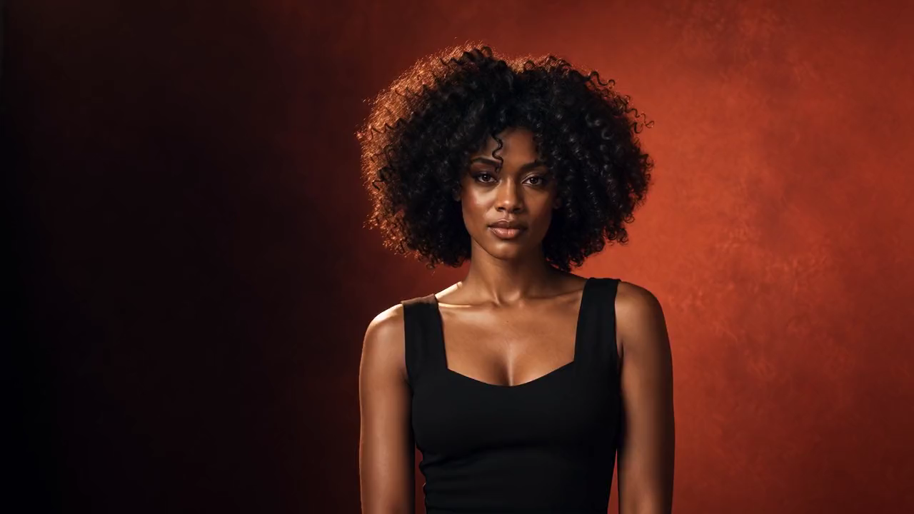 Sculptural natural curls in warm terracotta light