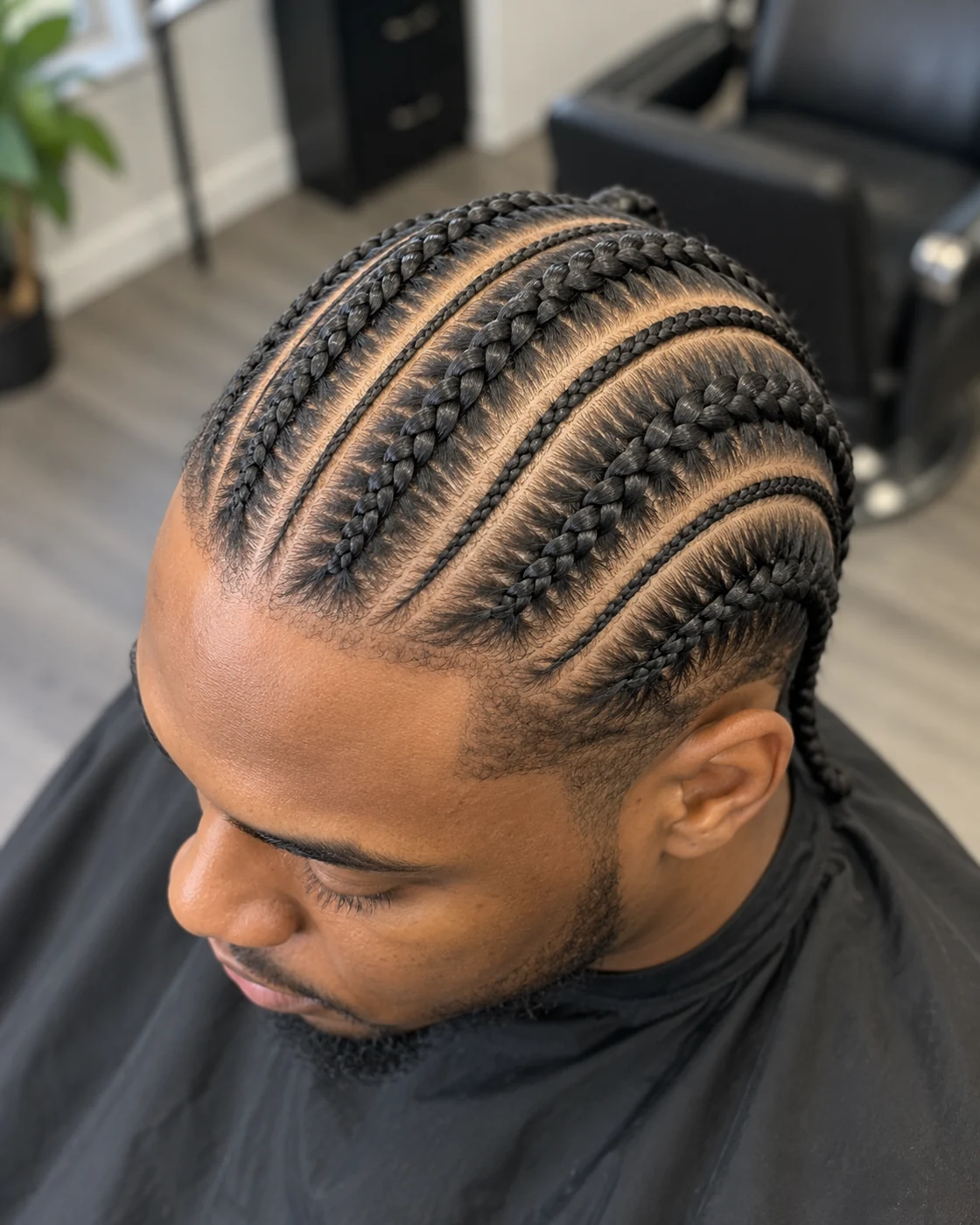 The full cornrow style, with curved partings and alternating braid widths